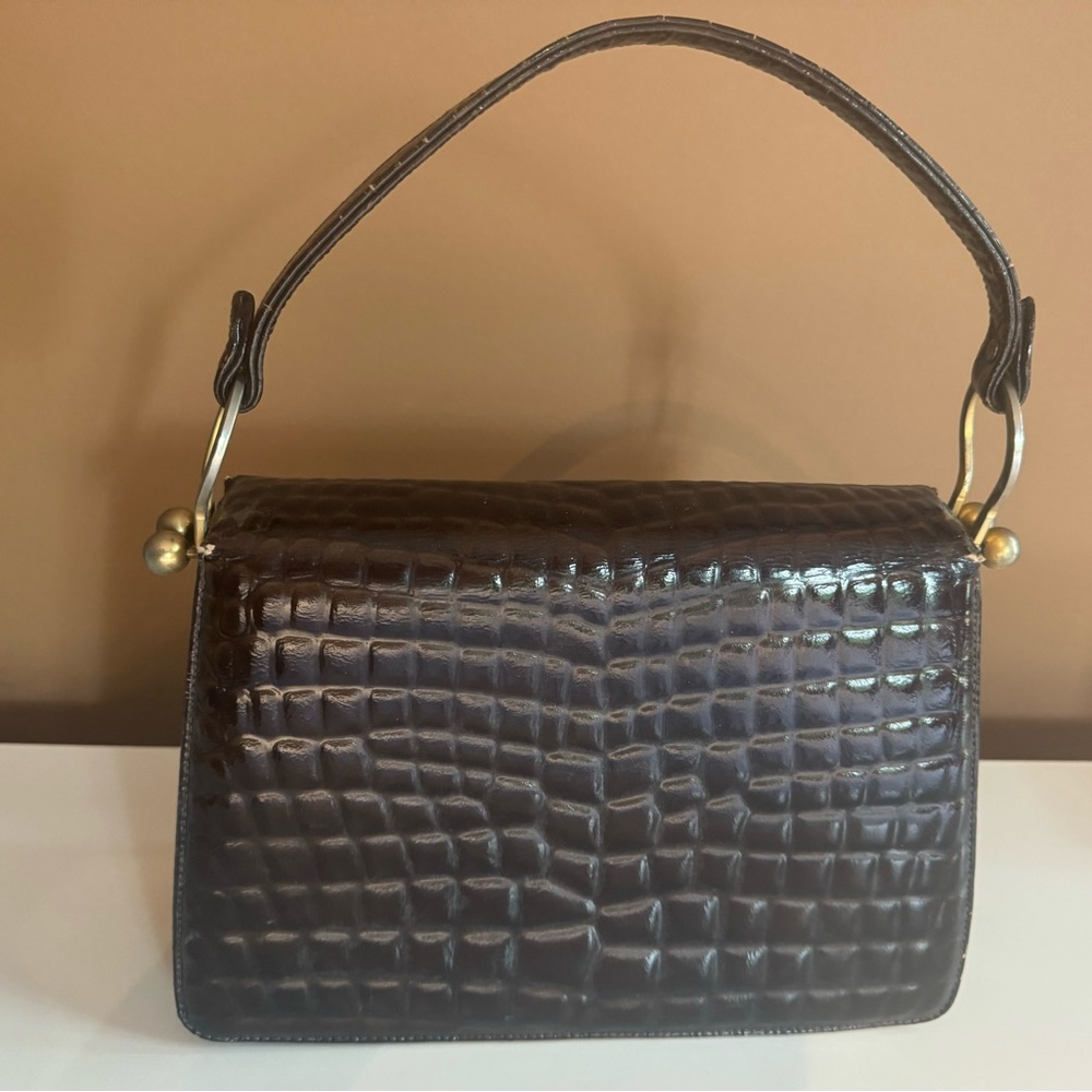 Vintage dark brown clutch purse. Embossed animal print with gold hardware.
